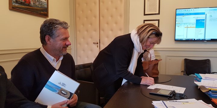 Buyers signing purchase documents at a notaire's office